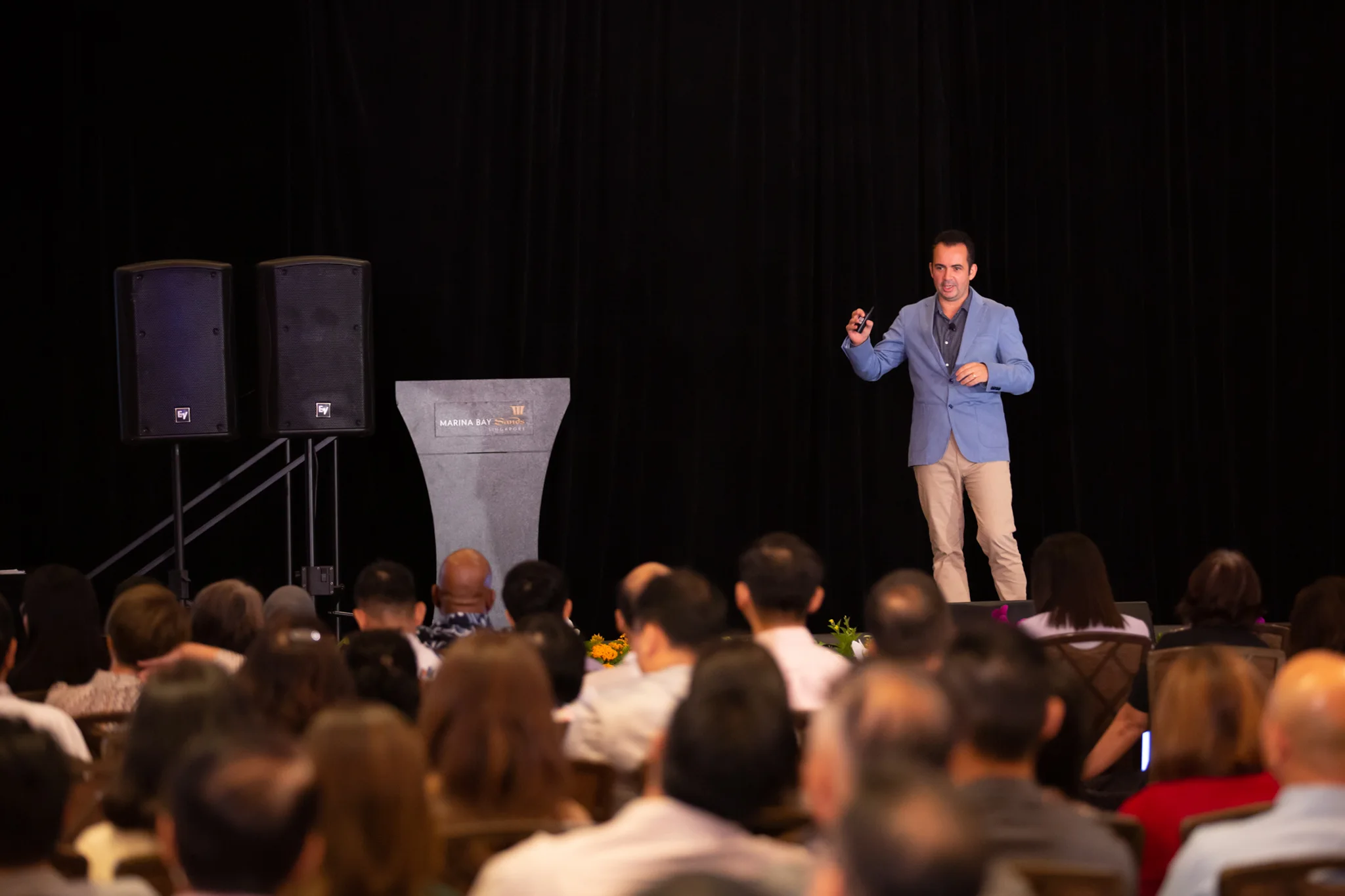 Marc Mekki speaking to an audience at Marina Bay Sands in Singapore