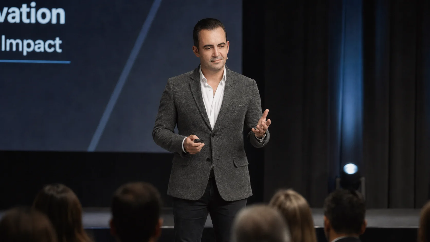 Marc Mekki speaking on stage in Singapore
